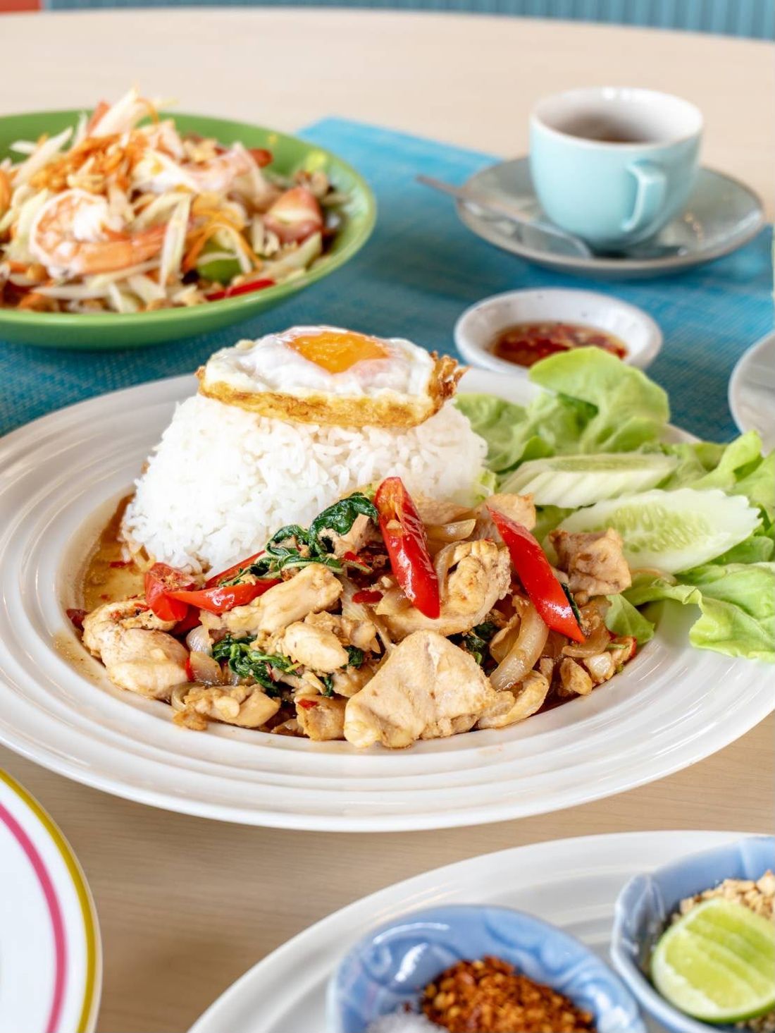 A Thai table — som tum, pad kra prow and iced coffee